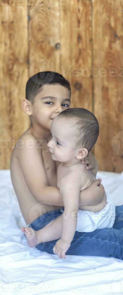 Happy childhood concept. Happy brothers portrait. 6 years and 6 months old boys having fun. Two little kids smiling having good time. Cute little brothers lying and playing together photo