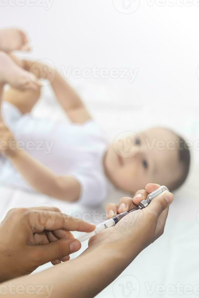 Doctor vaccinating a newborn baby boy. Child's Immunization, Children's Vaccination, Health concept. photo