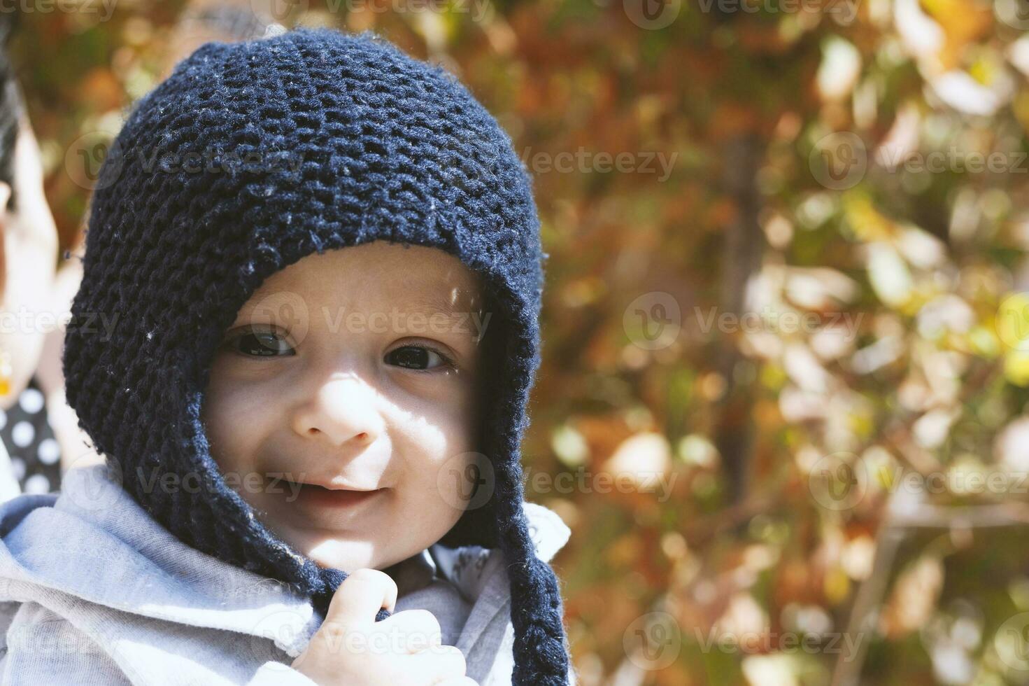 Portrait of 2-3 years old child in autumn garden photo