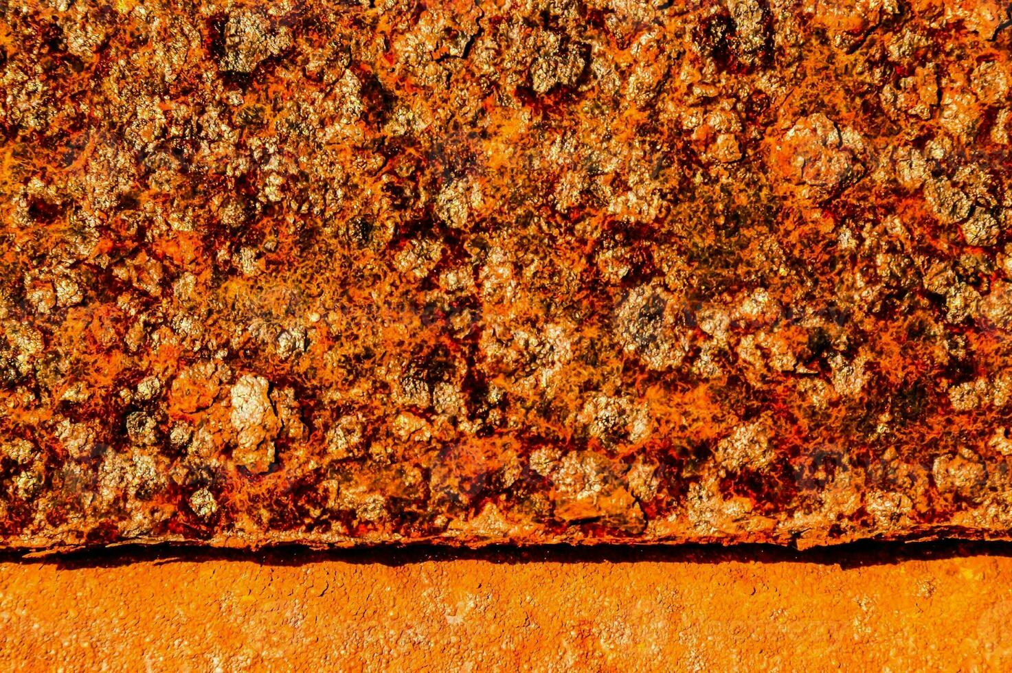 an orange rusted metal surface with a black background photo