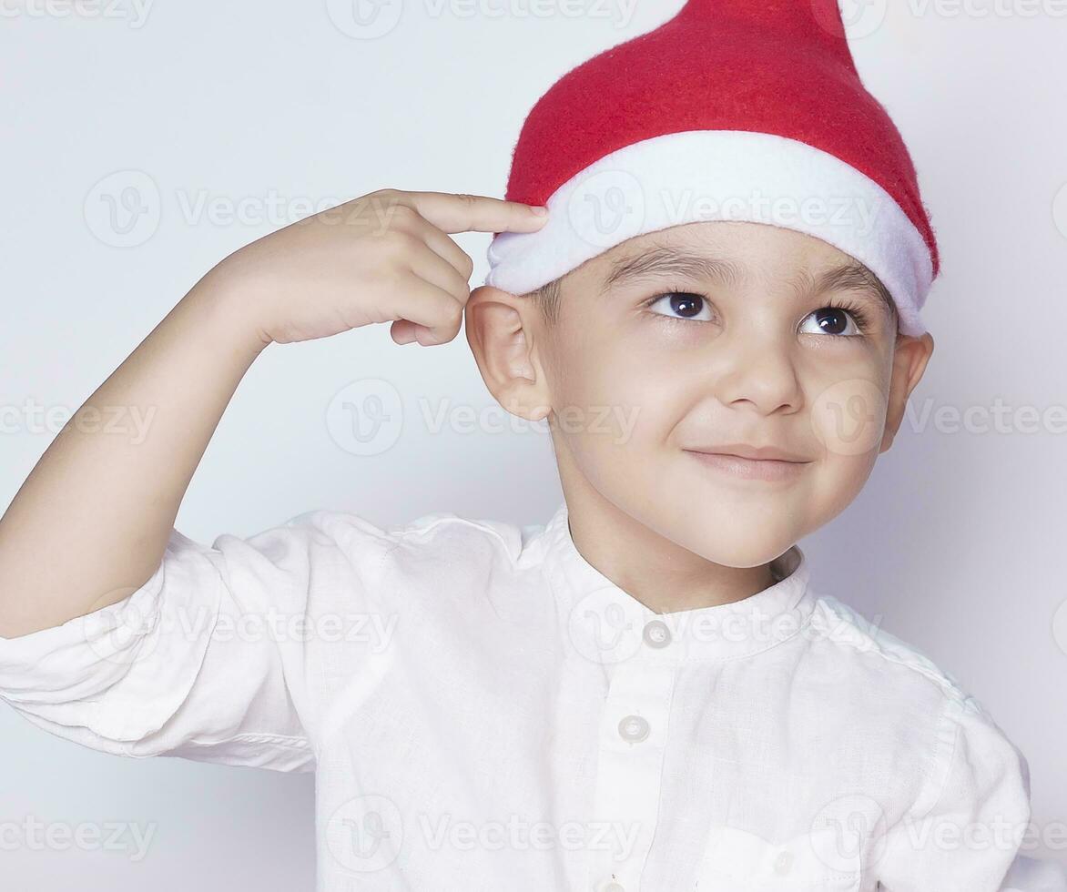 Boy asking are you idiot, are you serious or are you crazy. 6 year boy showing hand gesture. Kid portrait gesturing with fingers against photo