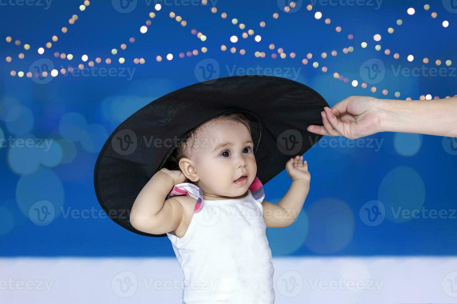 1-year-old baby girl in witch hat. Halloween celebration concept photo