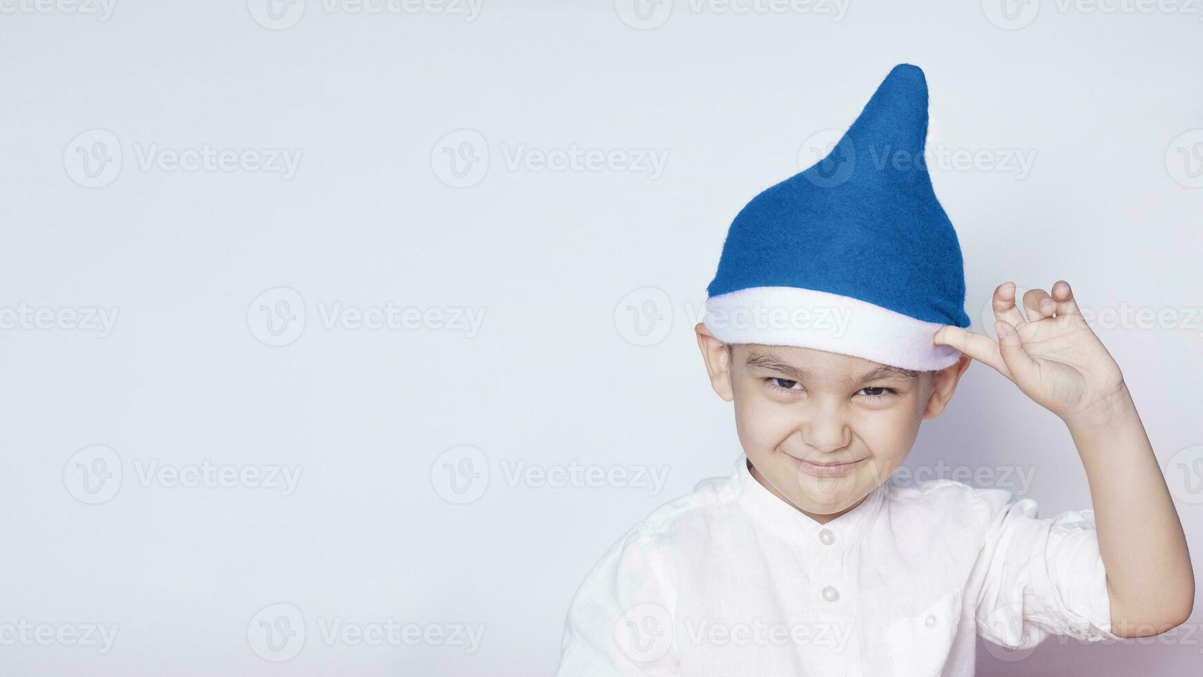 Boy asking are you idiot, are you serious or are you crazy. 6 year boy showing hand gesture. Kid portrait gesturing with fingers against photo