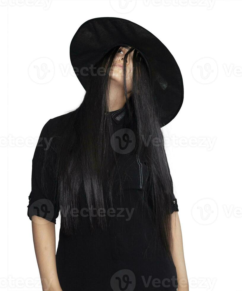 Portrait of young woman in witch costume isolated on white background. Halloween theme on white photo