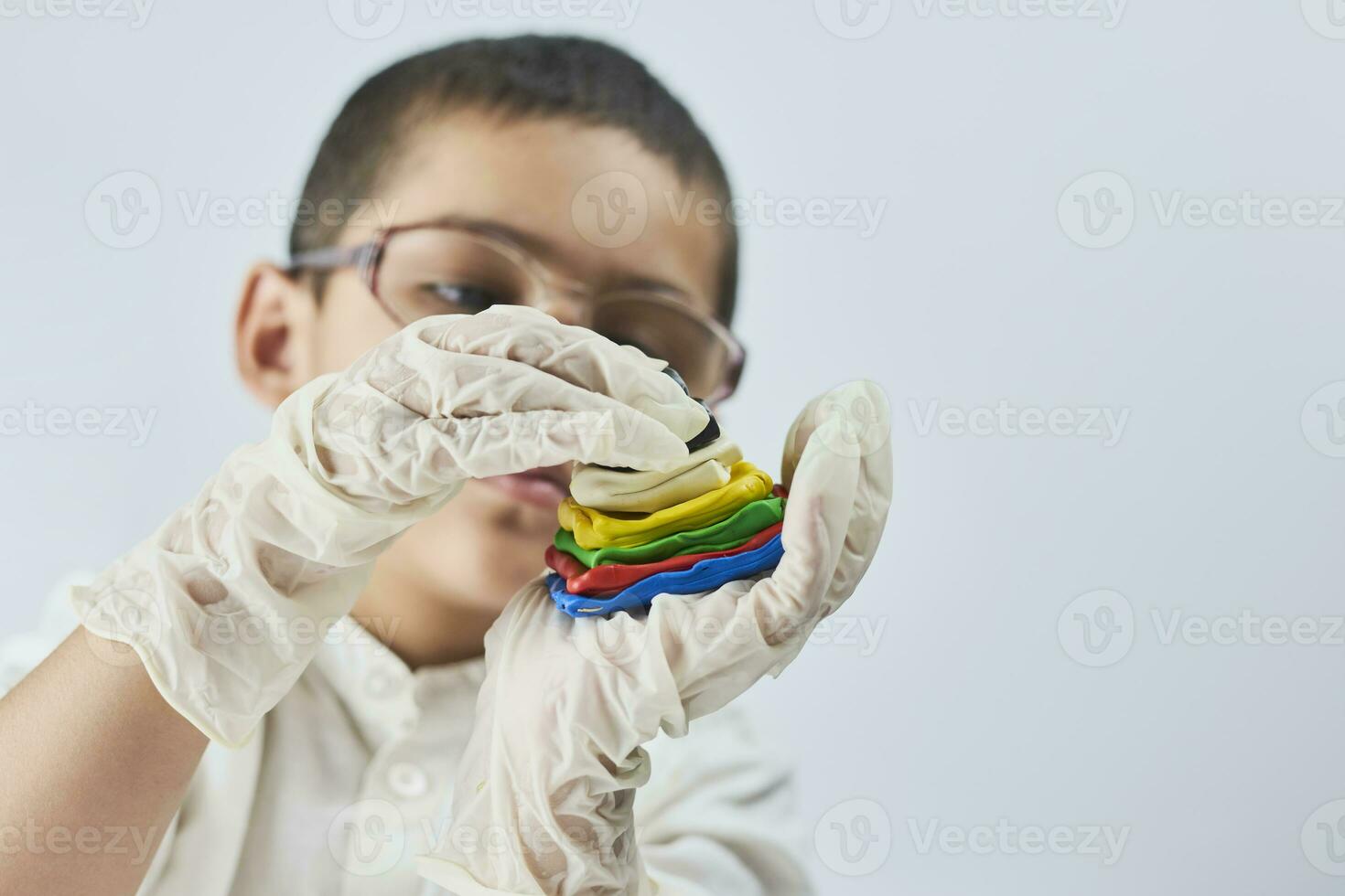 Little boy scientist in white making experiments photo