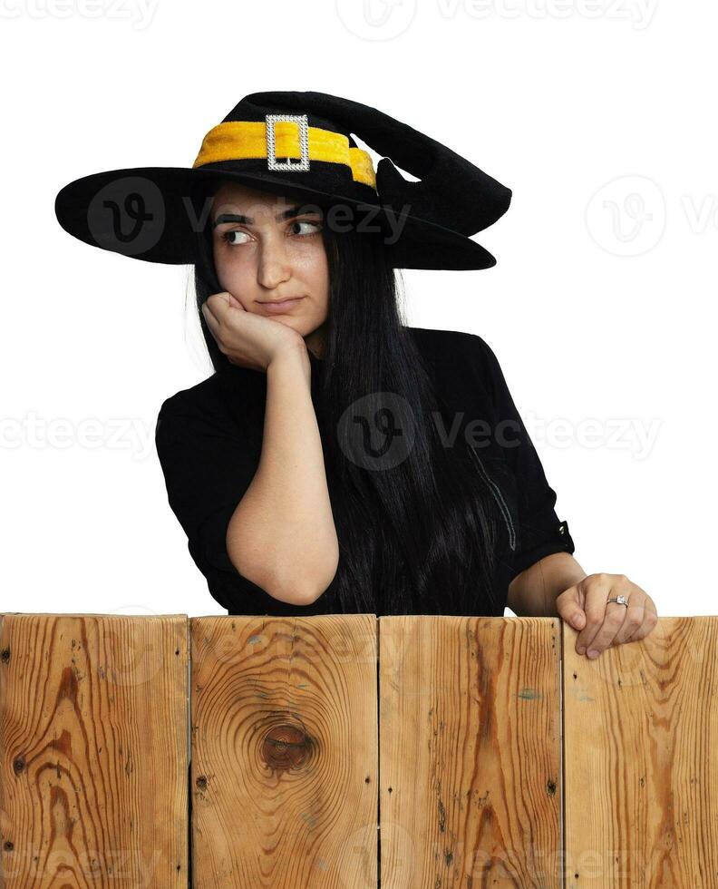 Halloween girl in witch costume on wooden board photo