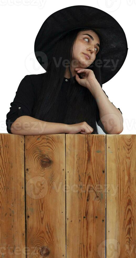 Halloween girl in witch costume on wooden board photo