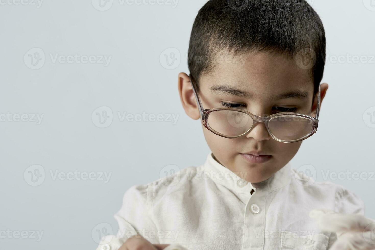 A smart mixed raced boy wearing glasses photo
