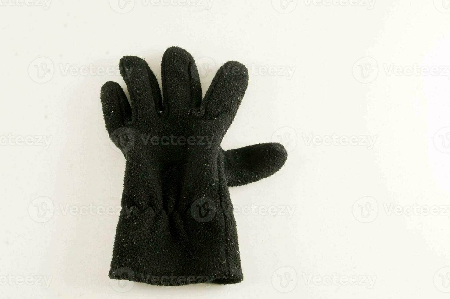 a black glove on a white surface photo