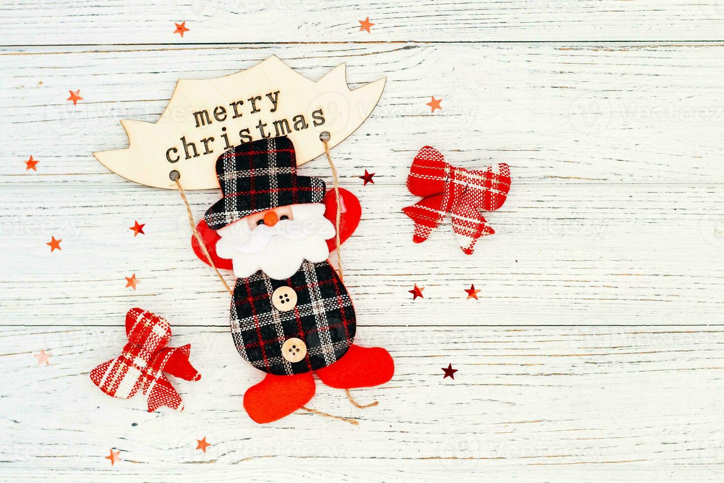 Santa toy for decoration on a white table, place for text photo