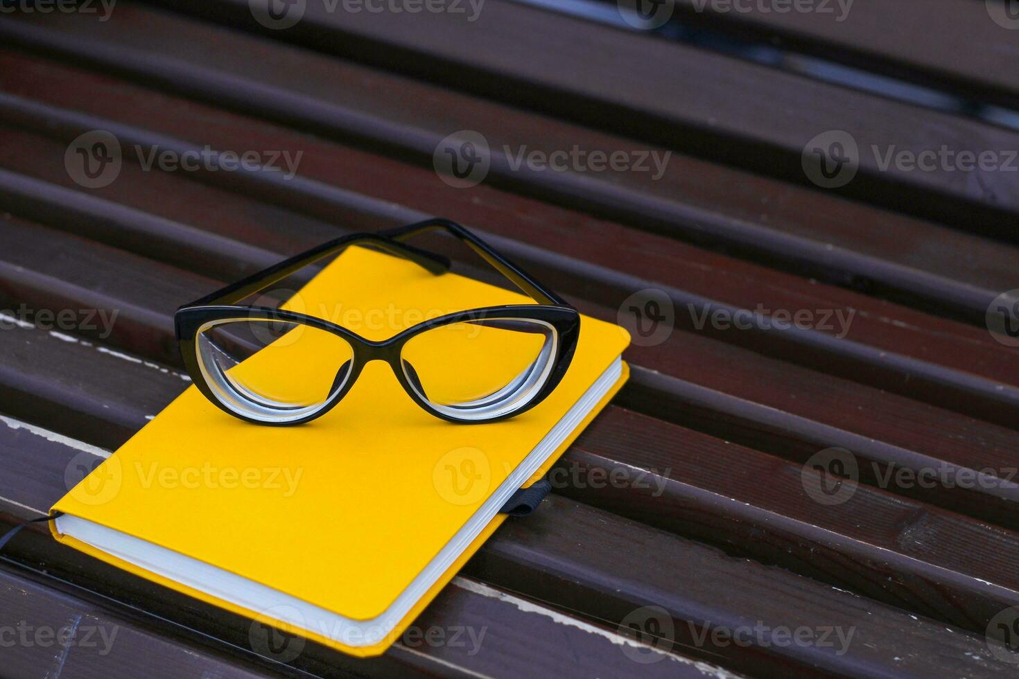 Eyeglasses on notepad, study concept, time management. photo