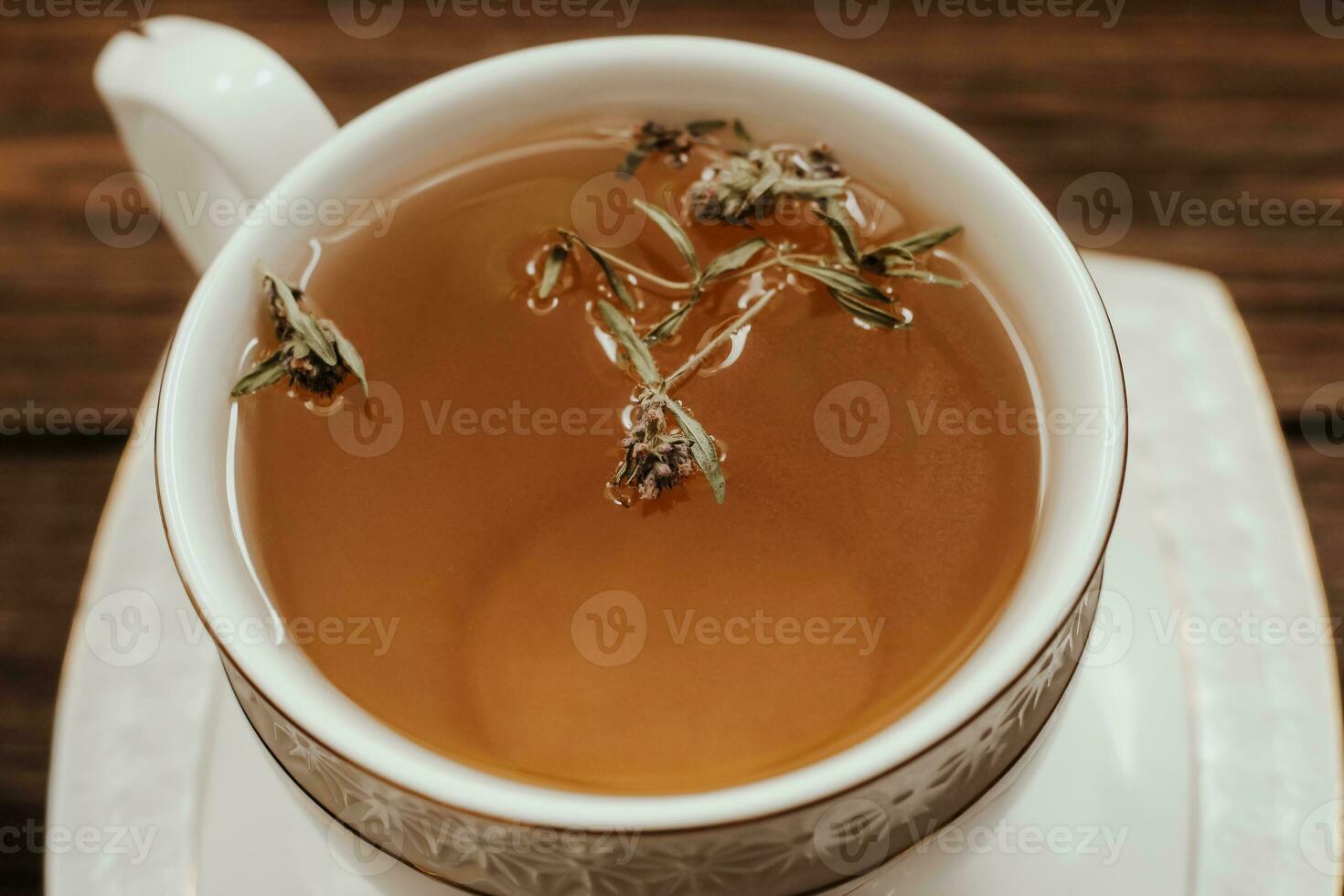 Herbal green tea in a white cup on the table. photo