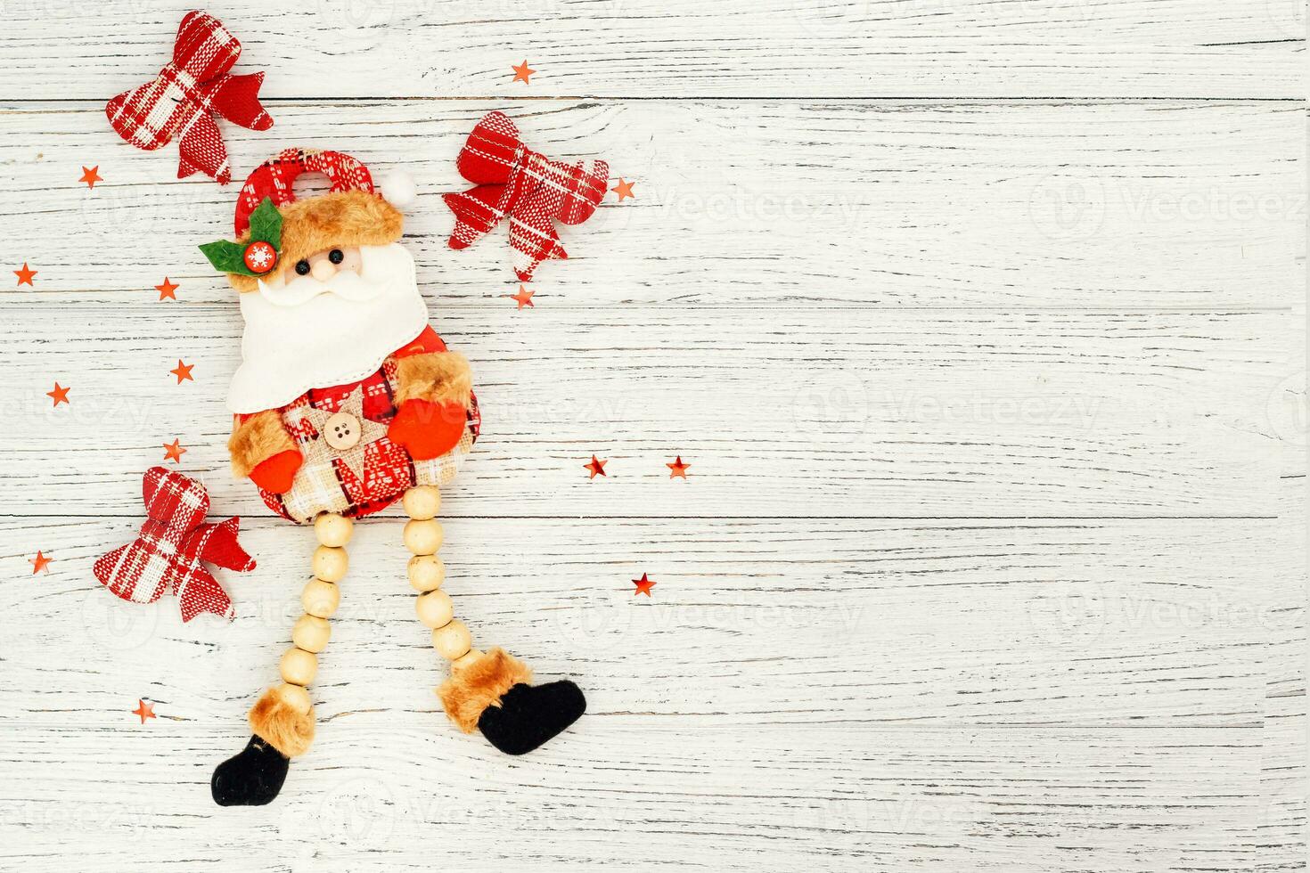 Santa toy for decoration on a white table, place for text photo