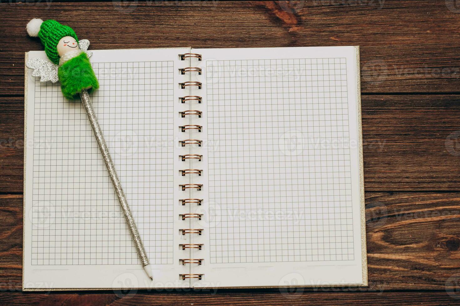 writing pen decorated with a Christmas snowman with a notebook photo