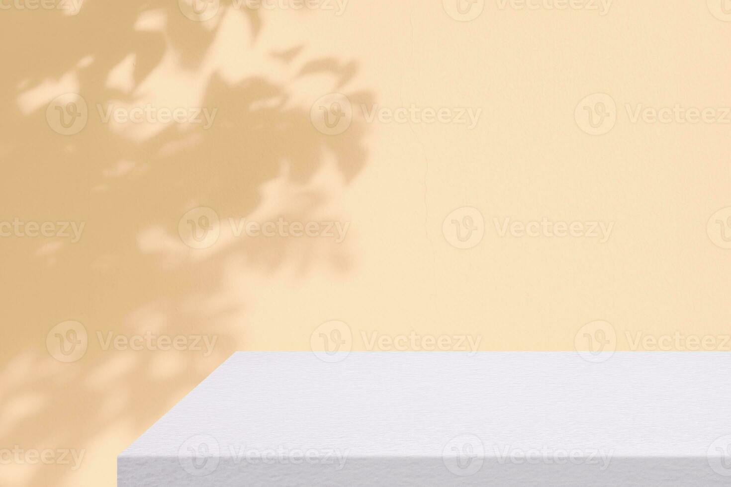 White Concrete Table Corner with Leaves on the Beige Concrete Wall Background, Suitable for Product Presentation Backdrop, Display, and Mock up. photo