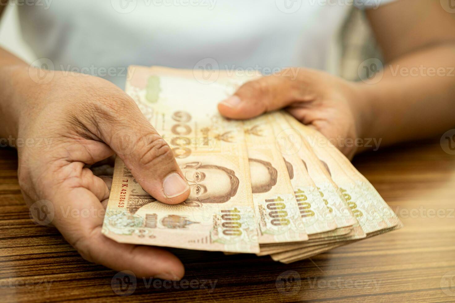 Asian business woman holding Thai banknote currency money. photo