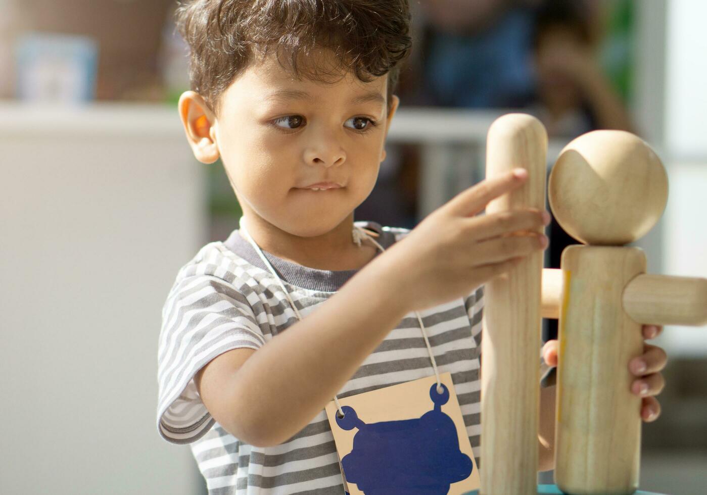Asian little boy playing with wood toys photo