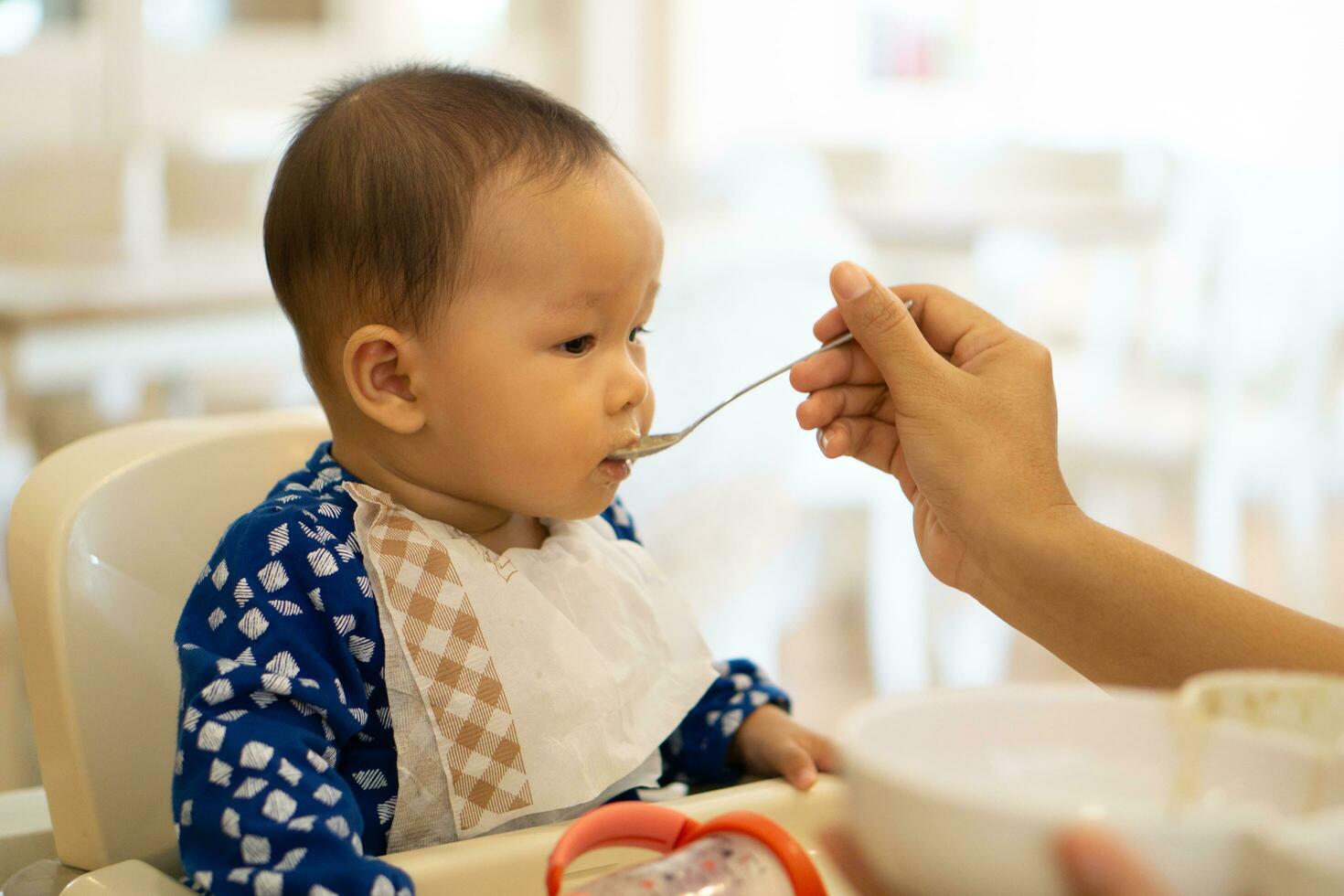 Babies are eating food in 6 month year olds photo