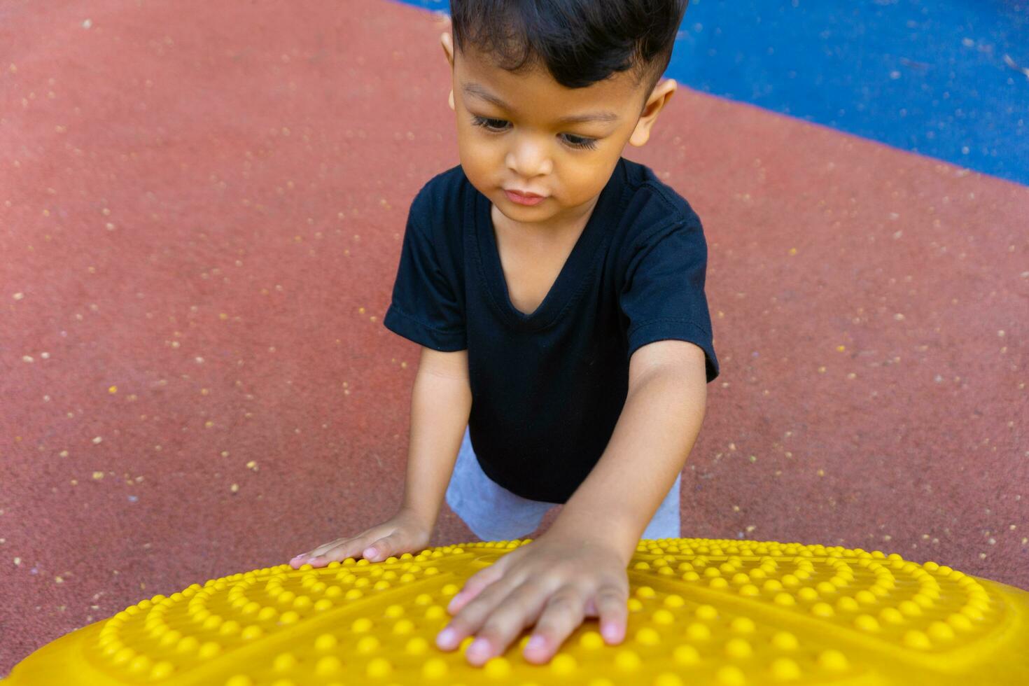 Little asian boy playing on the playground photo