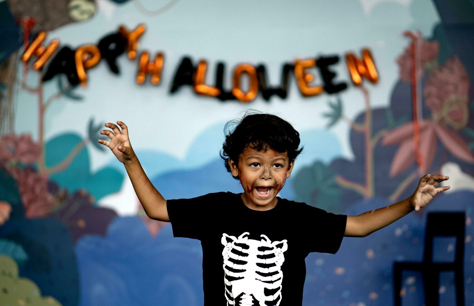 Cute and funny Asian boy posing to look scary for Happy Halloween photo