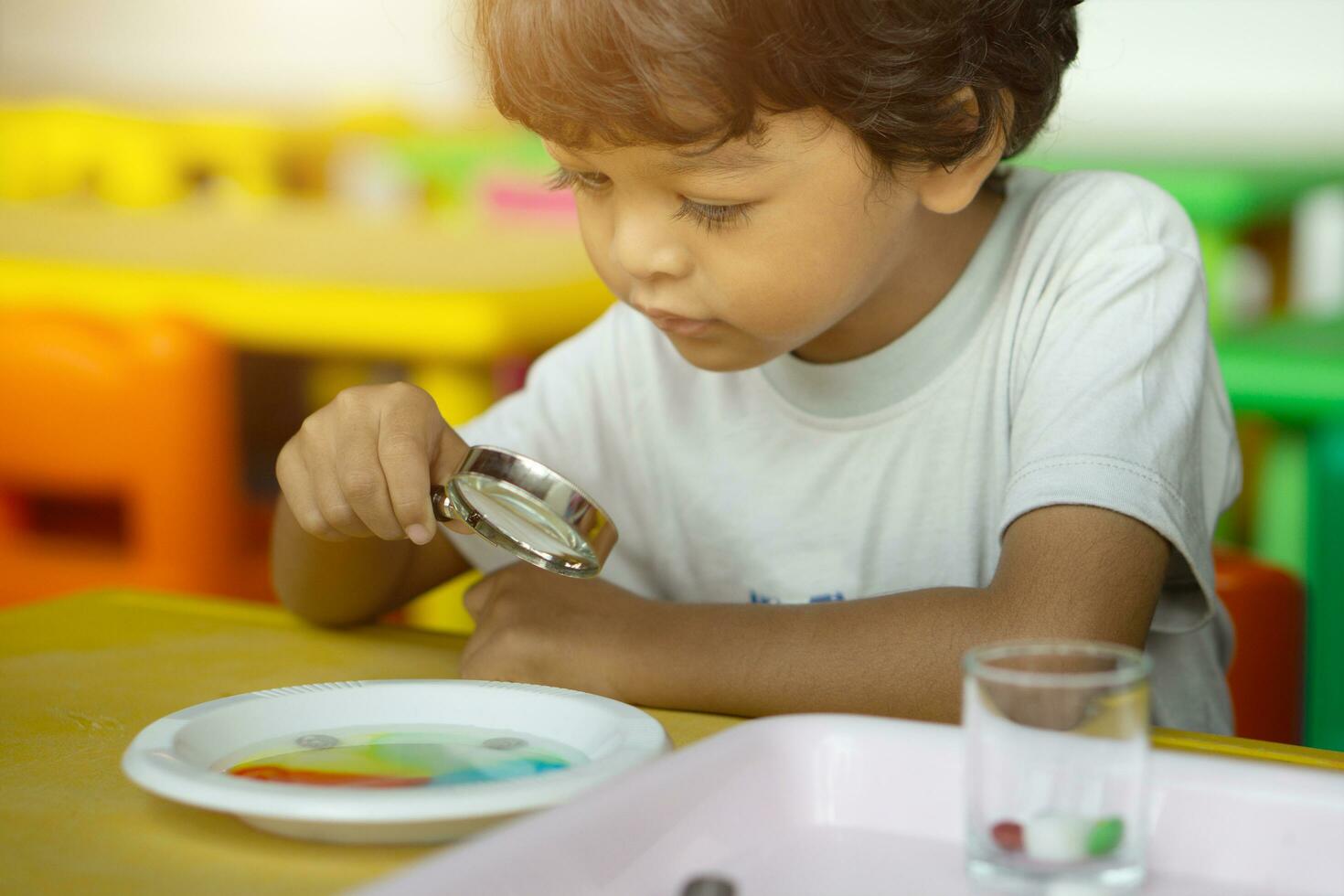 3 year old children in Asia are conducting scientific experiments. photo