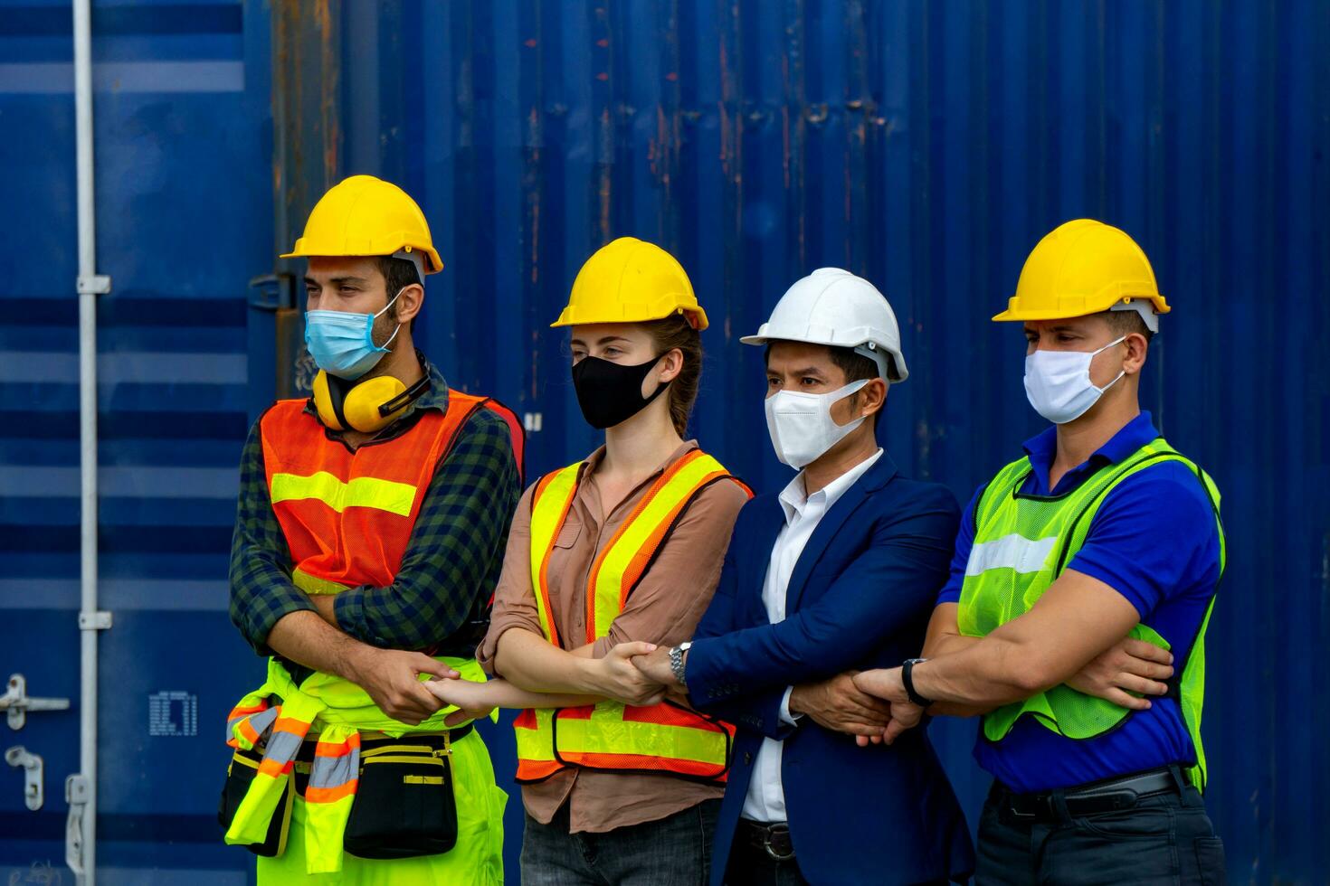 Industrial workers or engineers wearing Coronavirus or COVID-19 protective masks photo