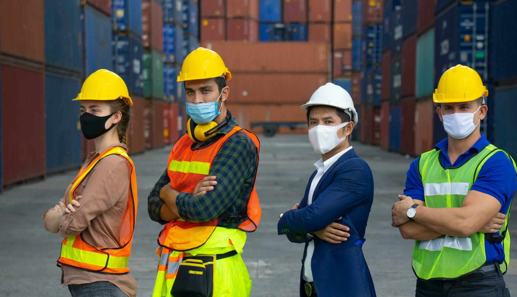 Industrial workers or engineers wearing Coronavirus or COVID-19 protective masks photo