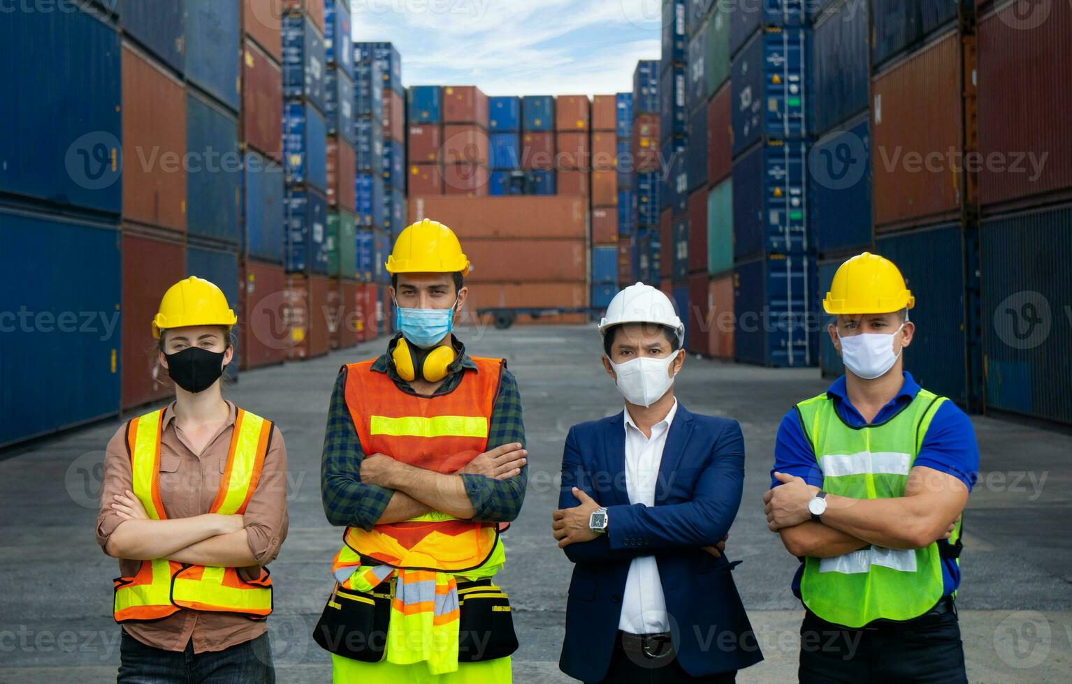 Industrial workers or engineers wearing Coronavirus or COVID-19 protective masks photo