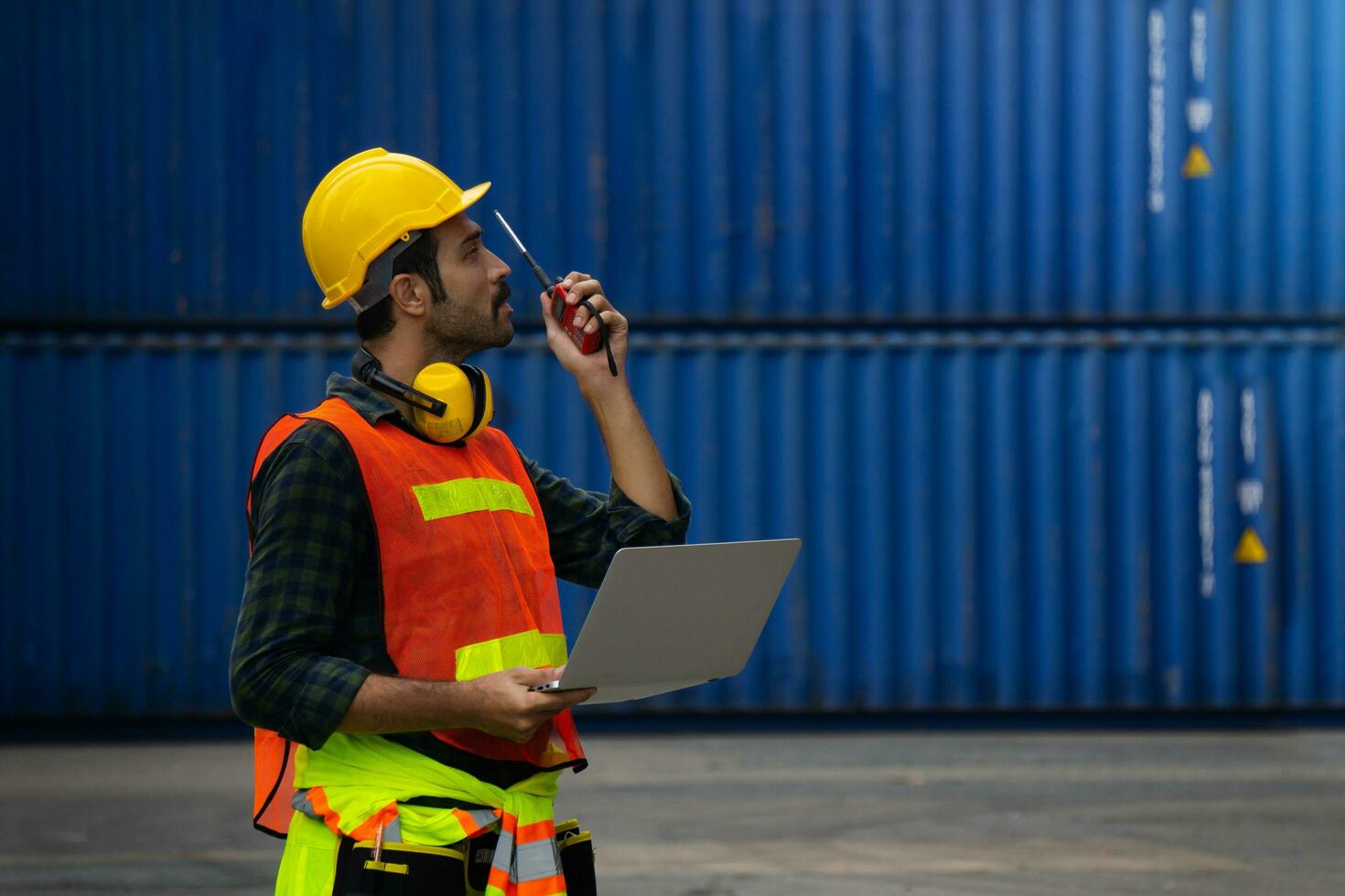 industrial worker is controlling container loading in import-export business. photo