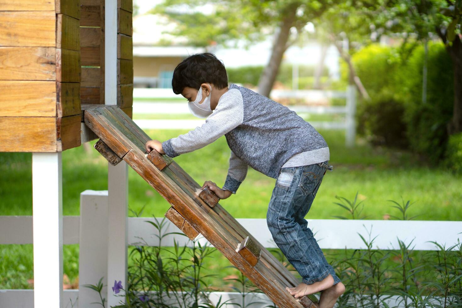 Asian Little boy climbing ladder on playground. photo
