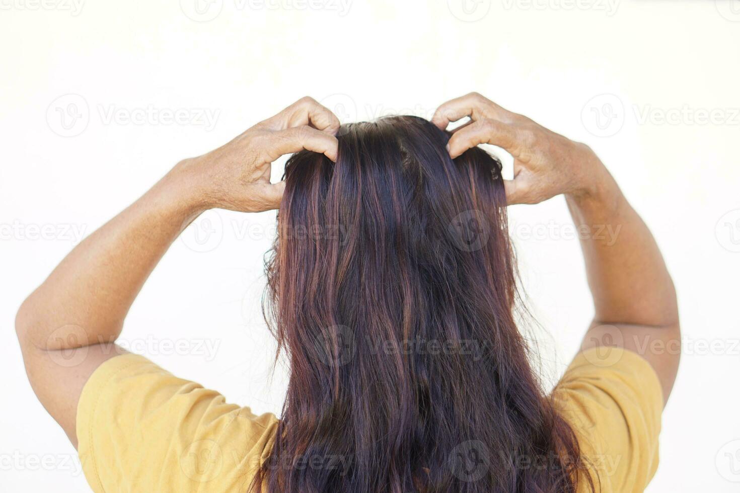 Woman use hands to scratch her itcy hair on head, isolated on white background. Concept, Hair health problems. Dandruff, fungus on scalp, allergic to shampoo or louse. photo