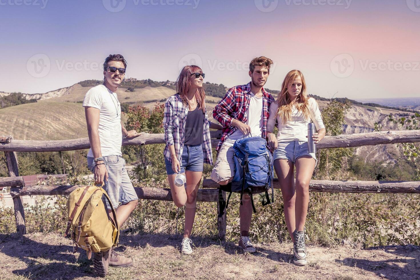 group of young hikers in the mountains preparing an excursion photo