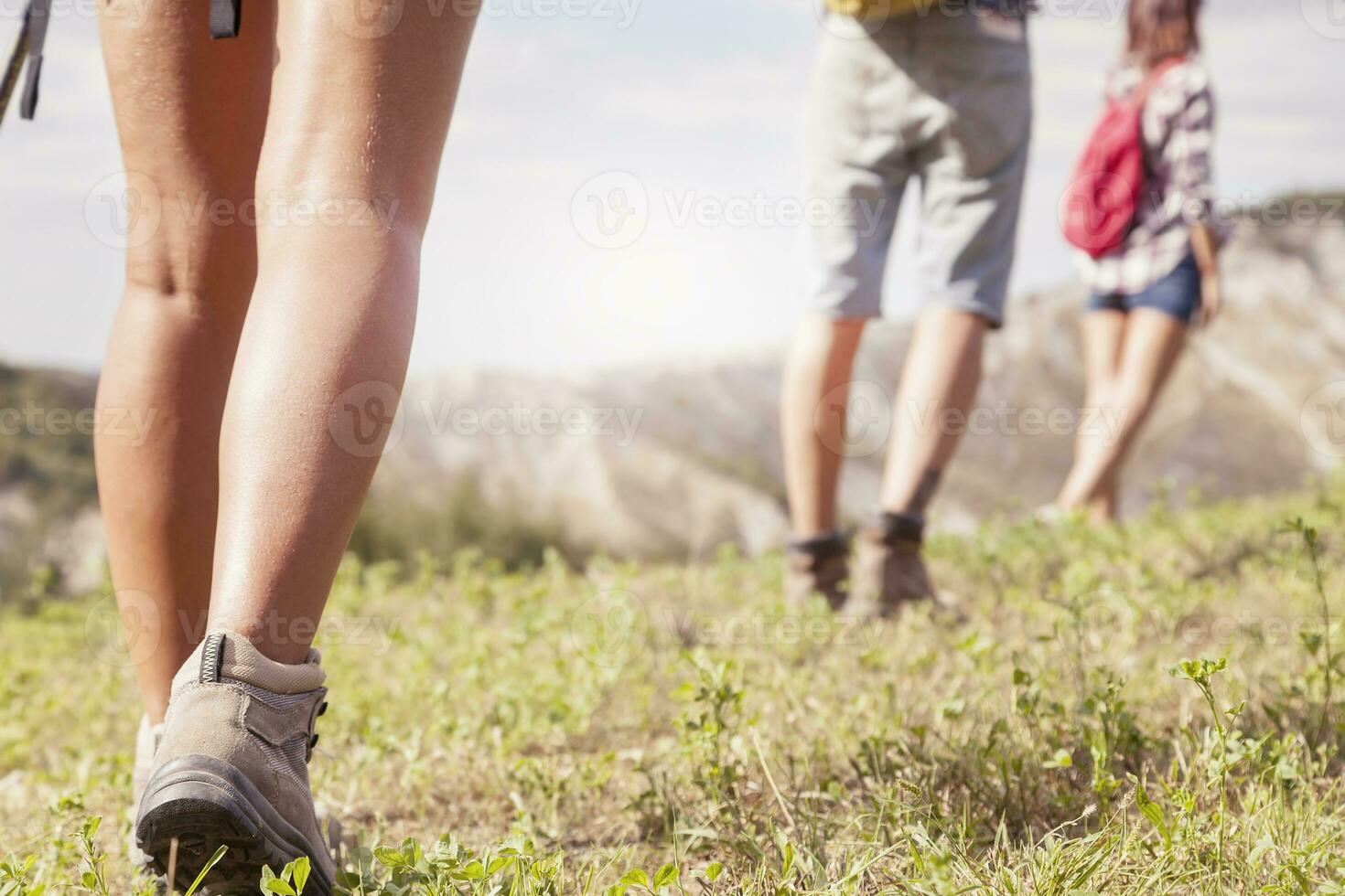 hiking legs walking on mountain grass photo