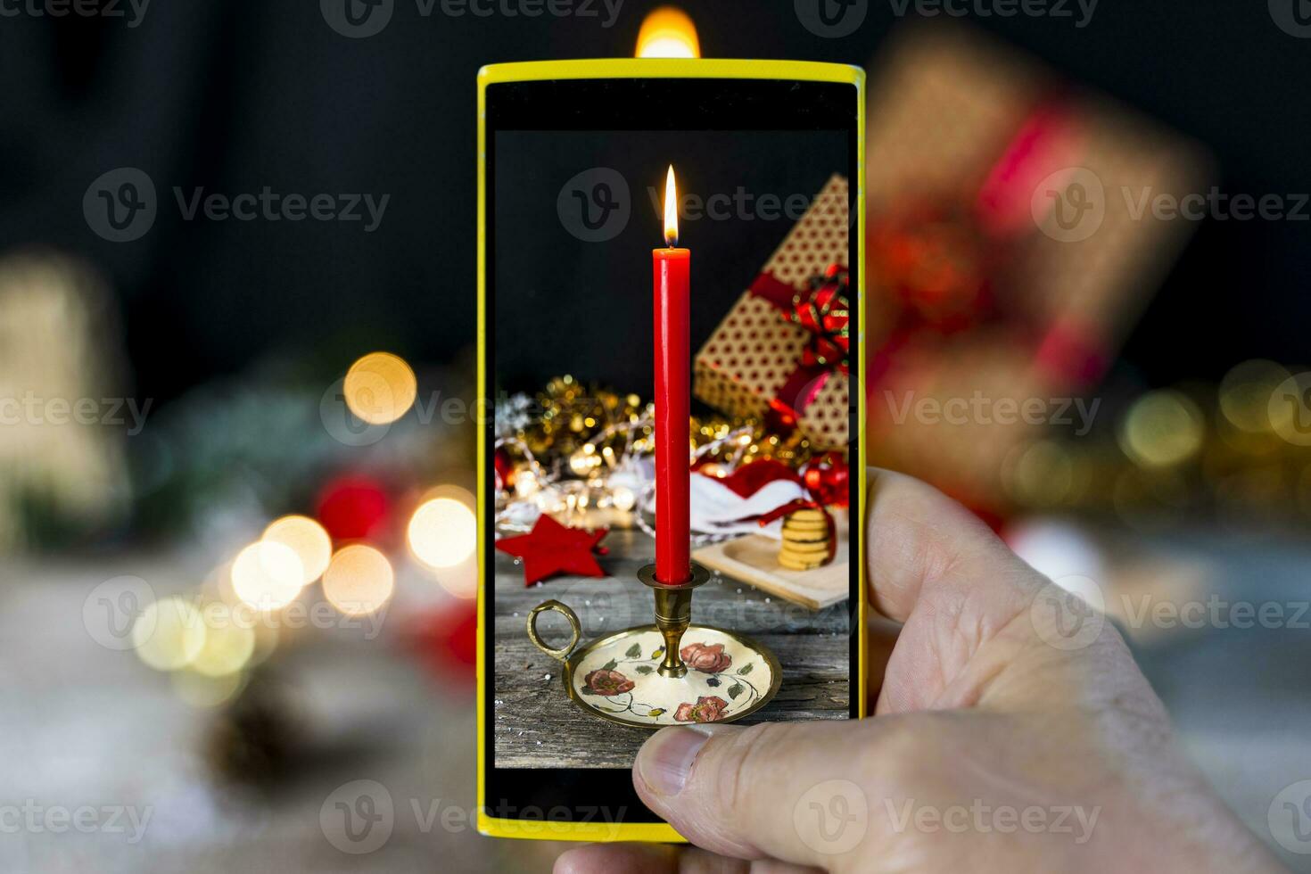 a man photographs the table with Christmas decorations with his smartphone photo