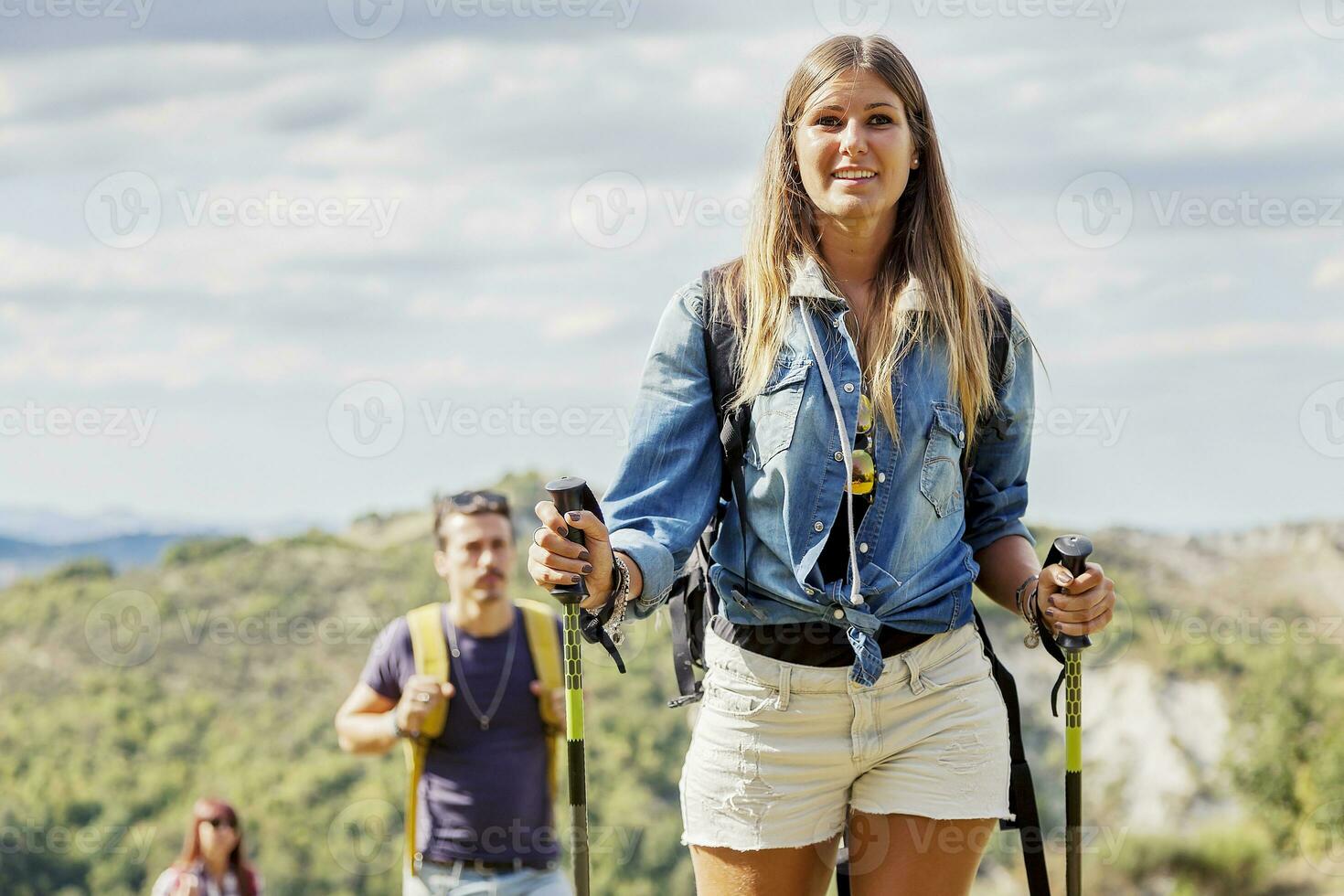 group of hikers in the mountain in single file photo