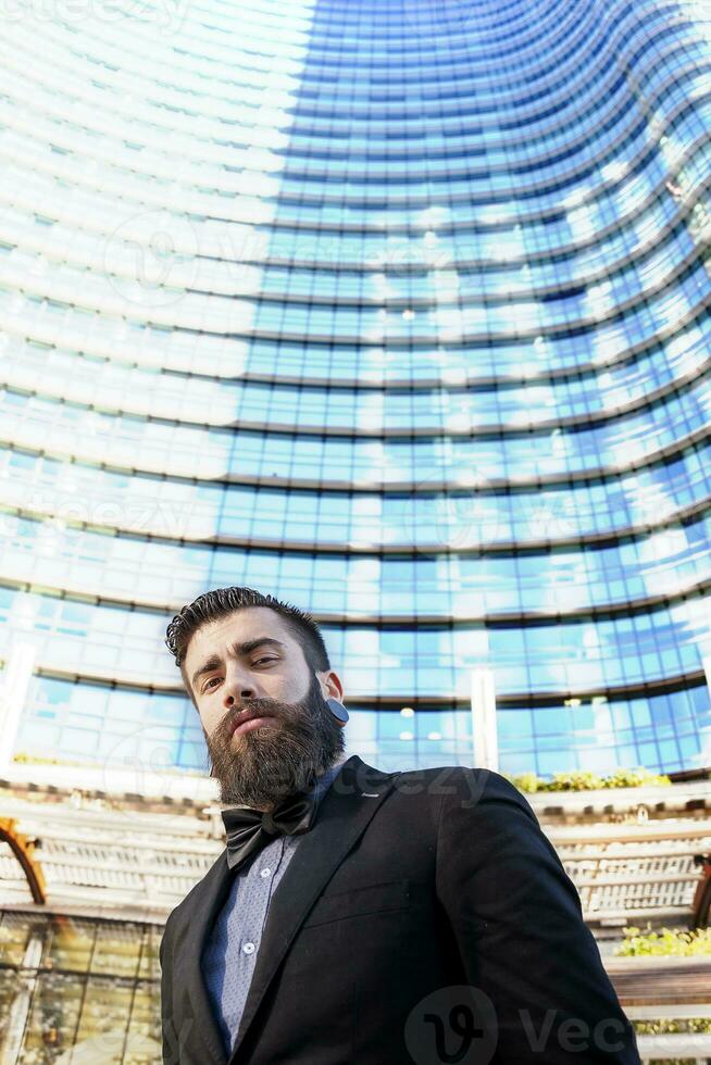 young businessman in a glass skyscraper photo