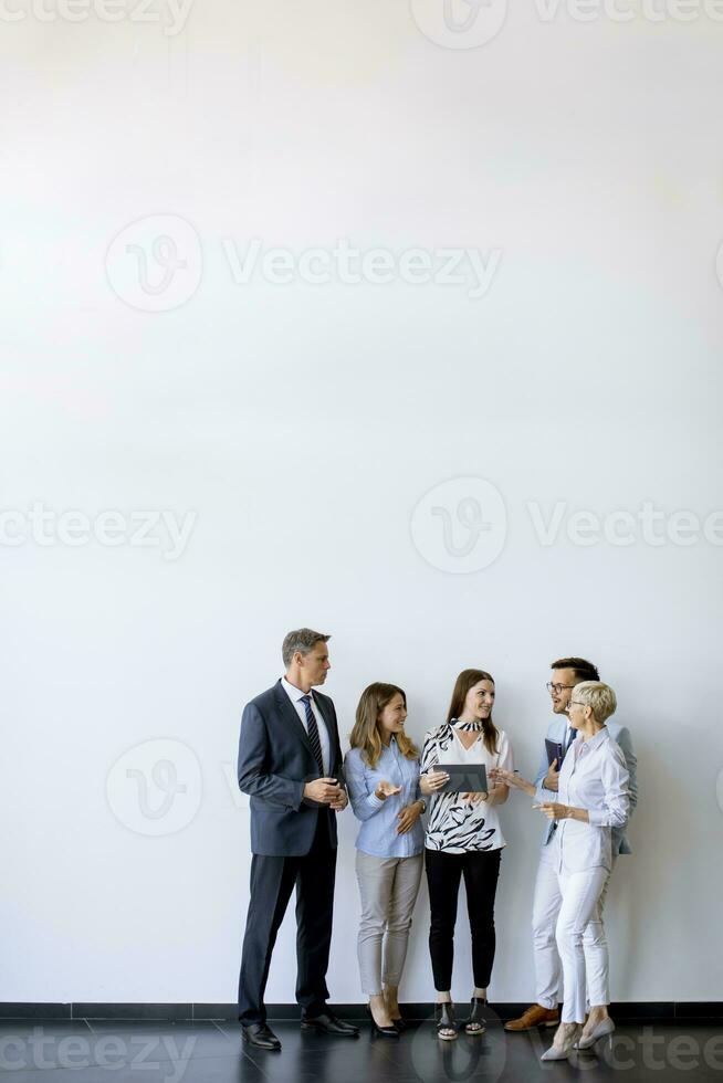 Business people standing by the wall in the office photo