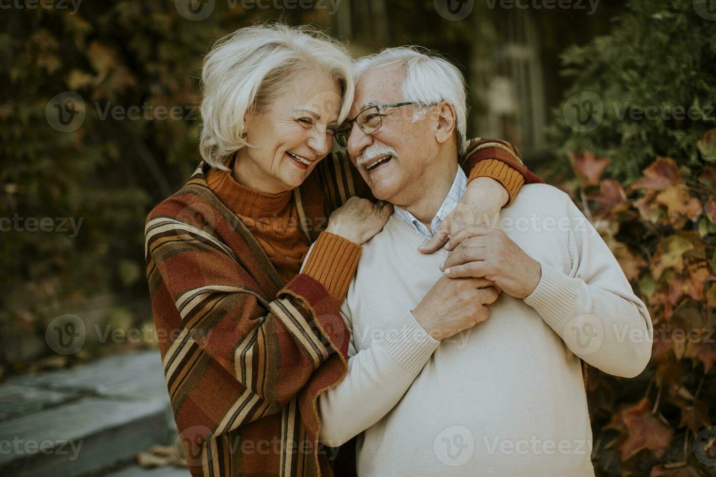 Senior couple embracing in autumn park photo