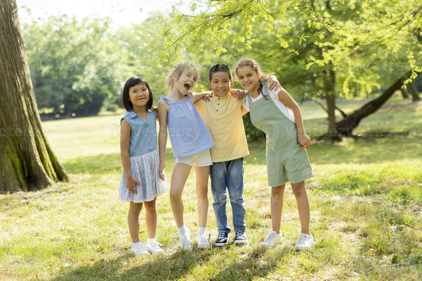 Group of asian and caucasian kids having fun in the park photo