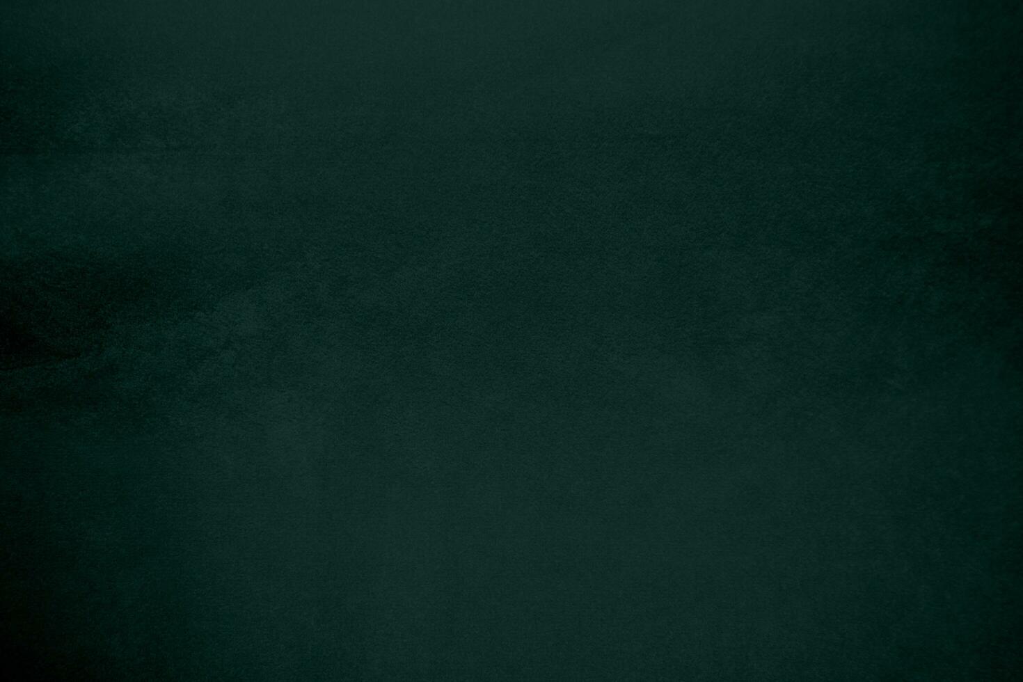 Green velvet fabric texture used as background. Emerald color panne fabric background of soft and smooth textile material. crushed velvet .luxury emerald tone for silk.. photo
