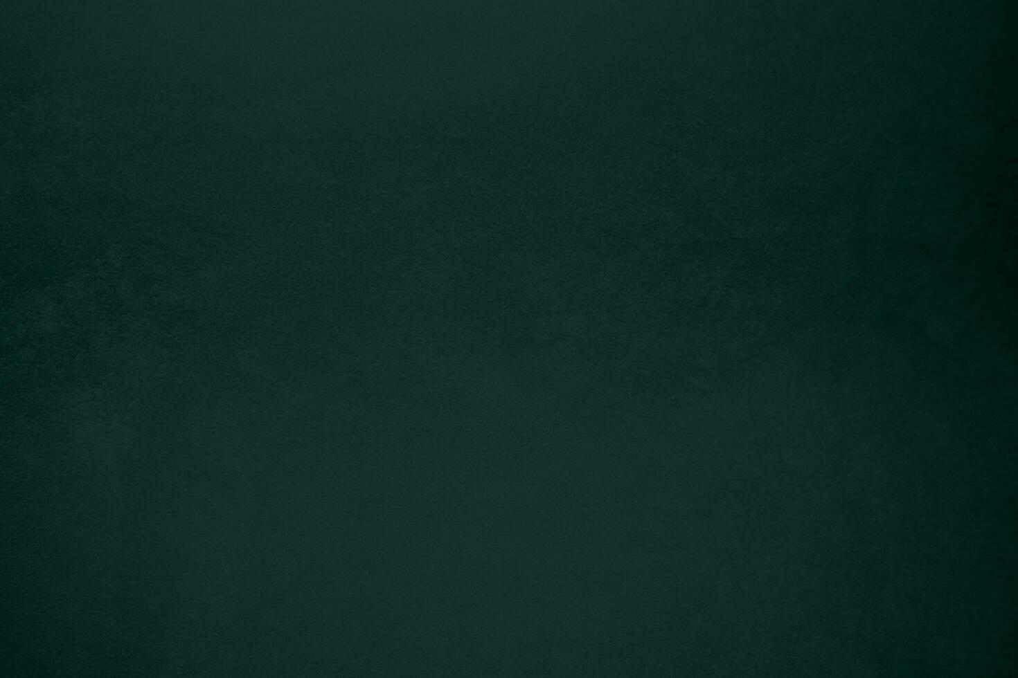 Green velvet fabric texture used as background. Emerald color panne fabric background of soft and smooth textile material. crushed velvet .luxury emerald tone for silk.. photo
