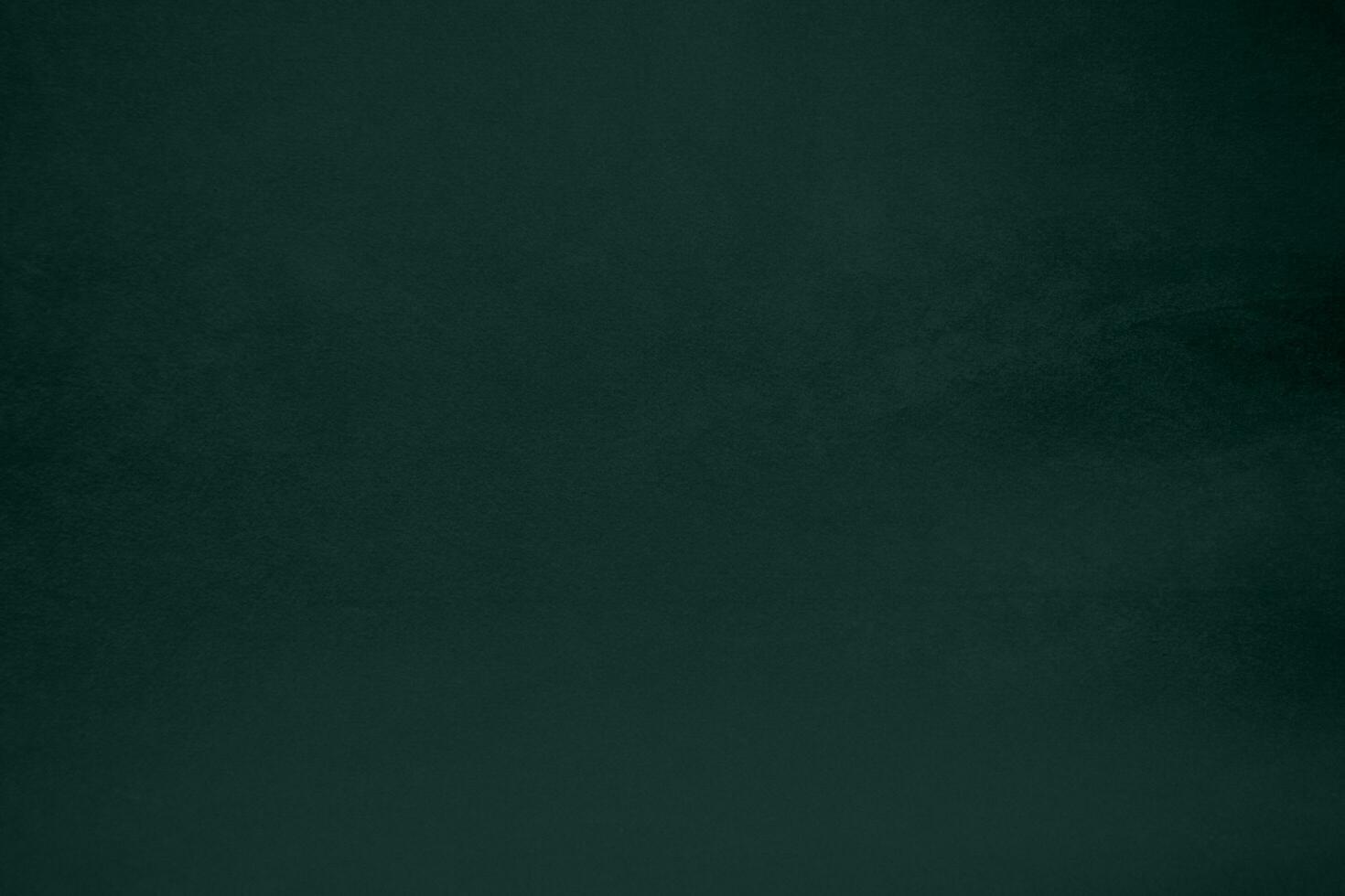 Green velvet fabric texture used as background. Emerald color panne fabric background of soft and smooth textile material. crushed velvet .luxury emerald tone for silk.. photo