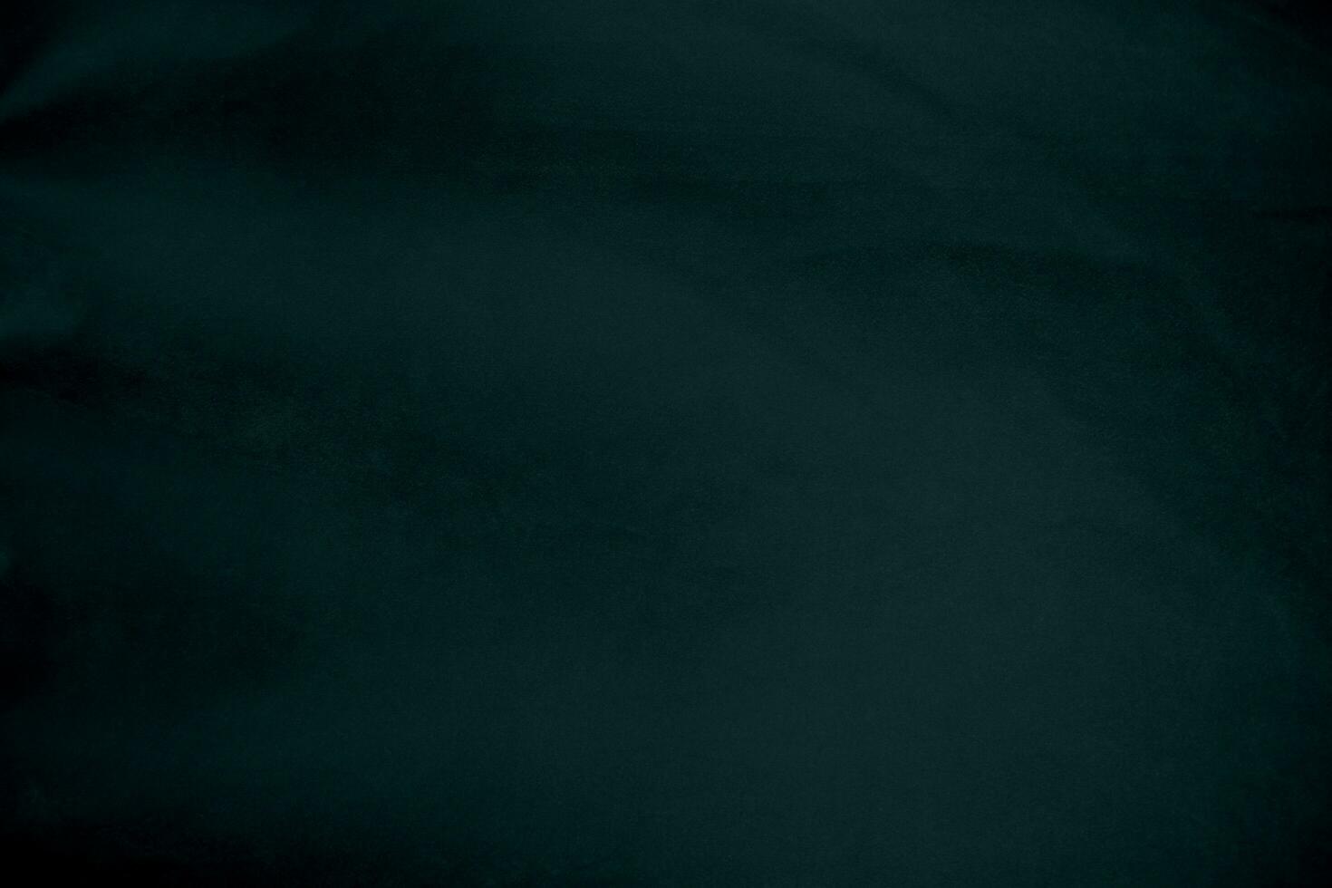 Dark green velvet fabric texture gradient used as background. Emerald color panne fabric background of soft and smooth textile material. crushed velvet .luxury emerald tone for silk. photo