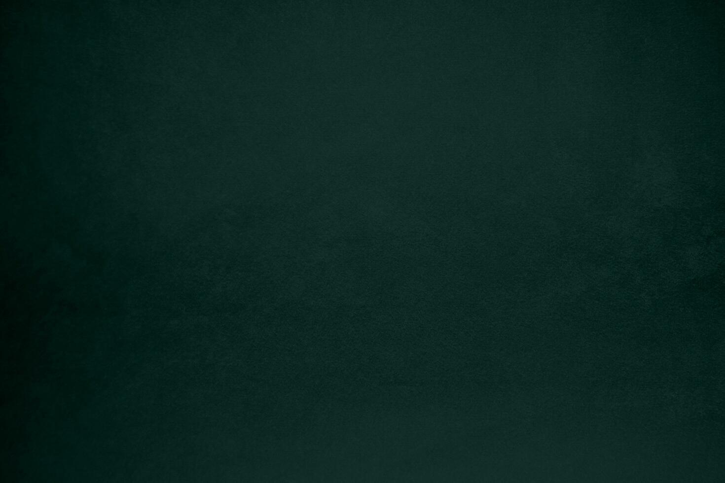 Green velvet fabric texture used as background. Emerald color panne fabric background of soft and smooth textile material. crushed velvet .luxury emerald tone for silk.. photo