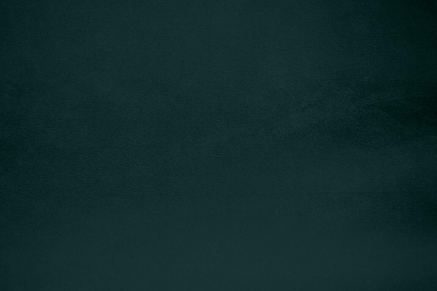 Dark green velvet fabric texture gradient used as background. Emerald color panne fabric background of soft and smooth textile material. crushed velvet .luxury emerald tone for silk. photo