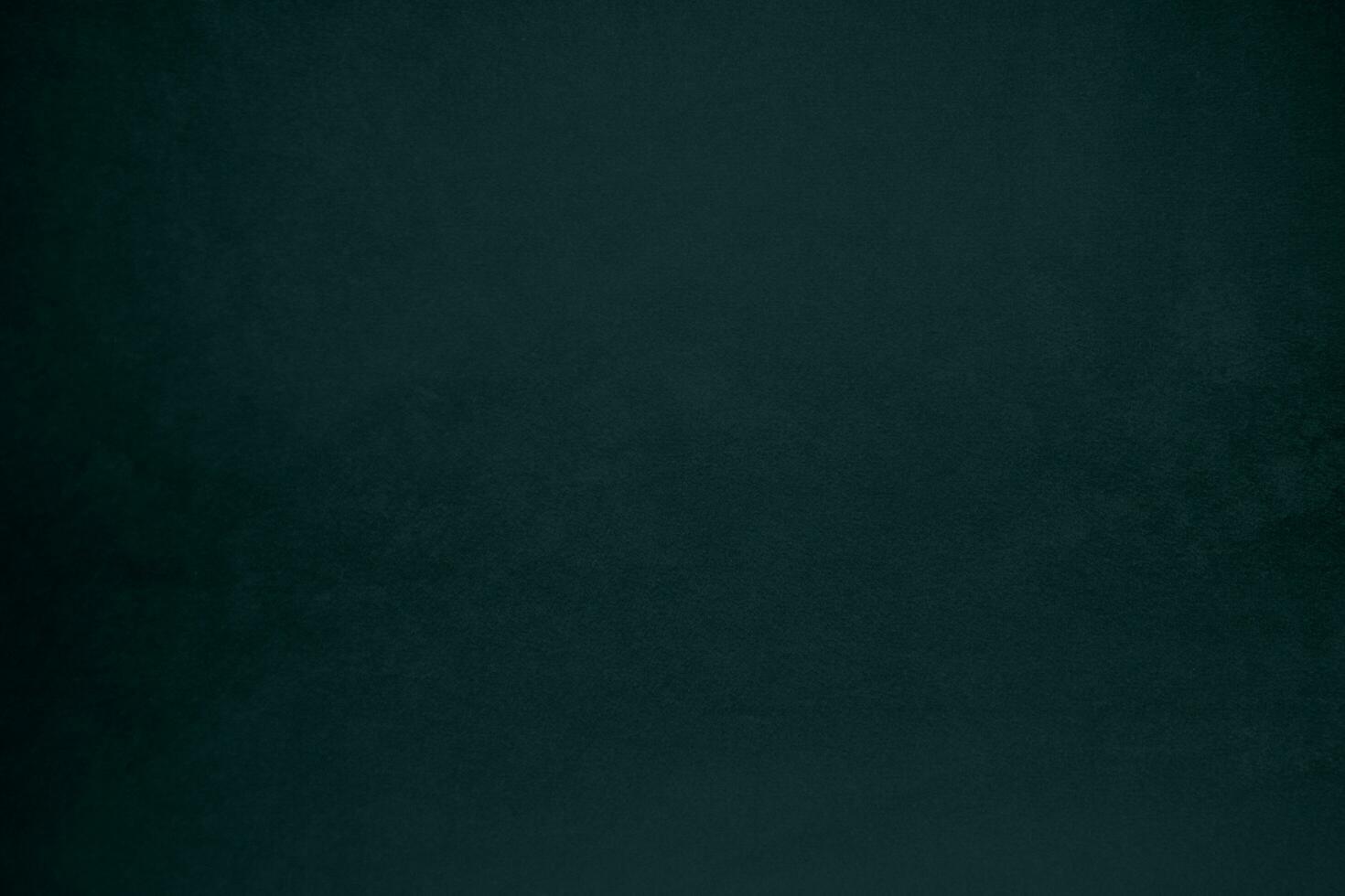 Dark green velvet fabric texture gradient used as background. Emerald color panne fabric background of soft and smooth textile material. crushed velvet .luxury emerald tone for silk. photo