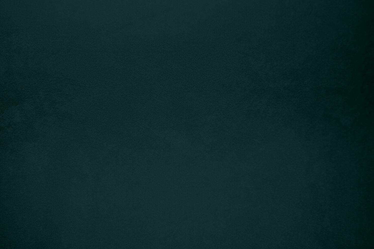 Dark green velvet fabric texture gradient used as background. Emerald color panne fabric background of soft and smooth textile material. crushed velvet .luxury emerald tone for silk. photo