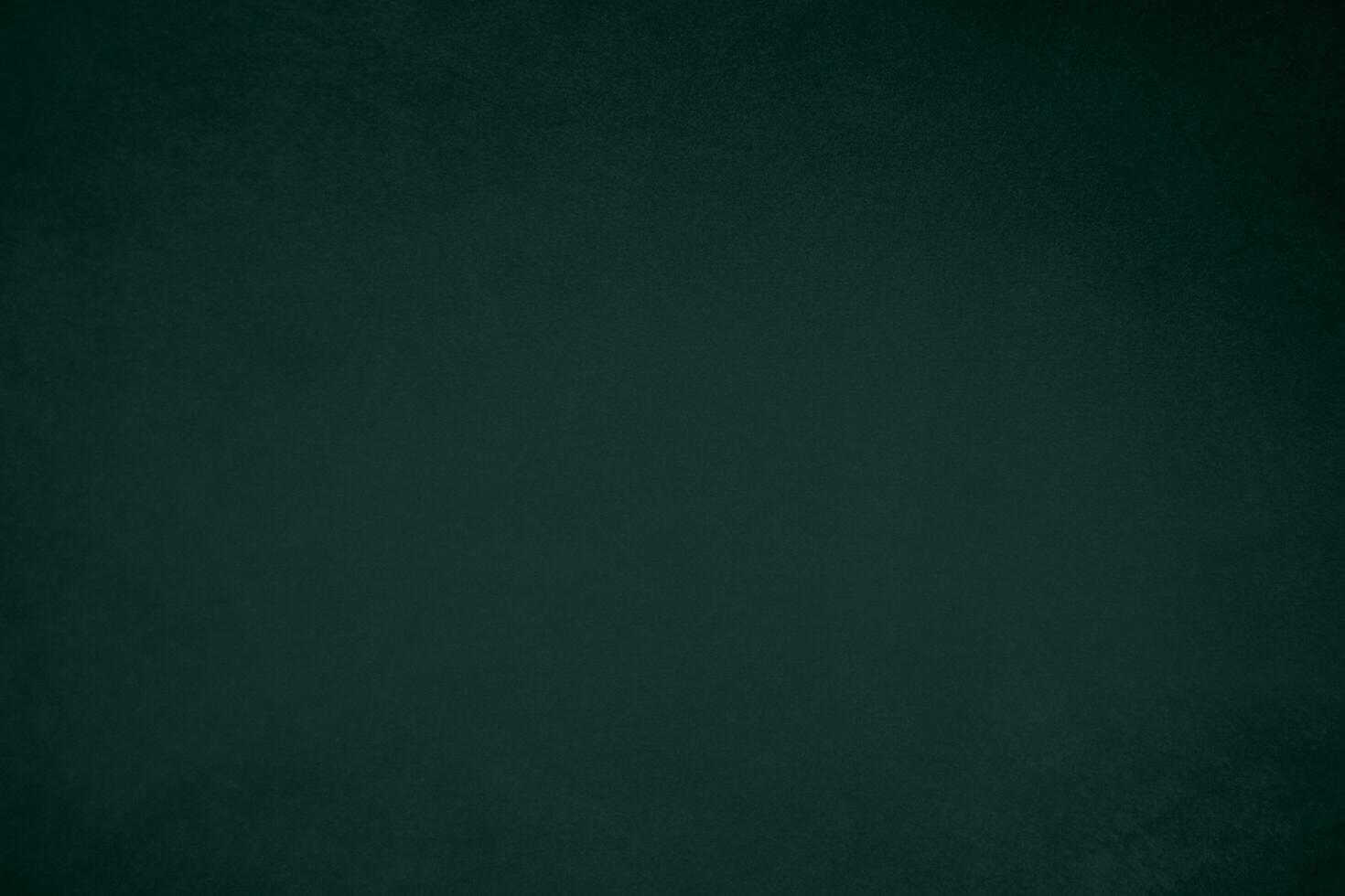 Green velvet fabric texture used as background. Emerald color panne fabric background of soft and smooth textile material. crushed velvet .luxury emerald tone for silk.. photo