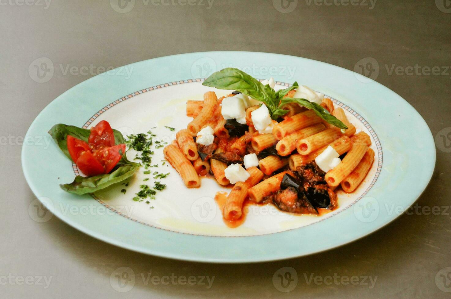 Italian cuisine. First dishes. Pasta, rigati with eggplant and mozzarella. photo