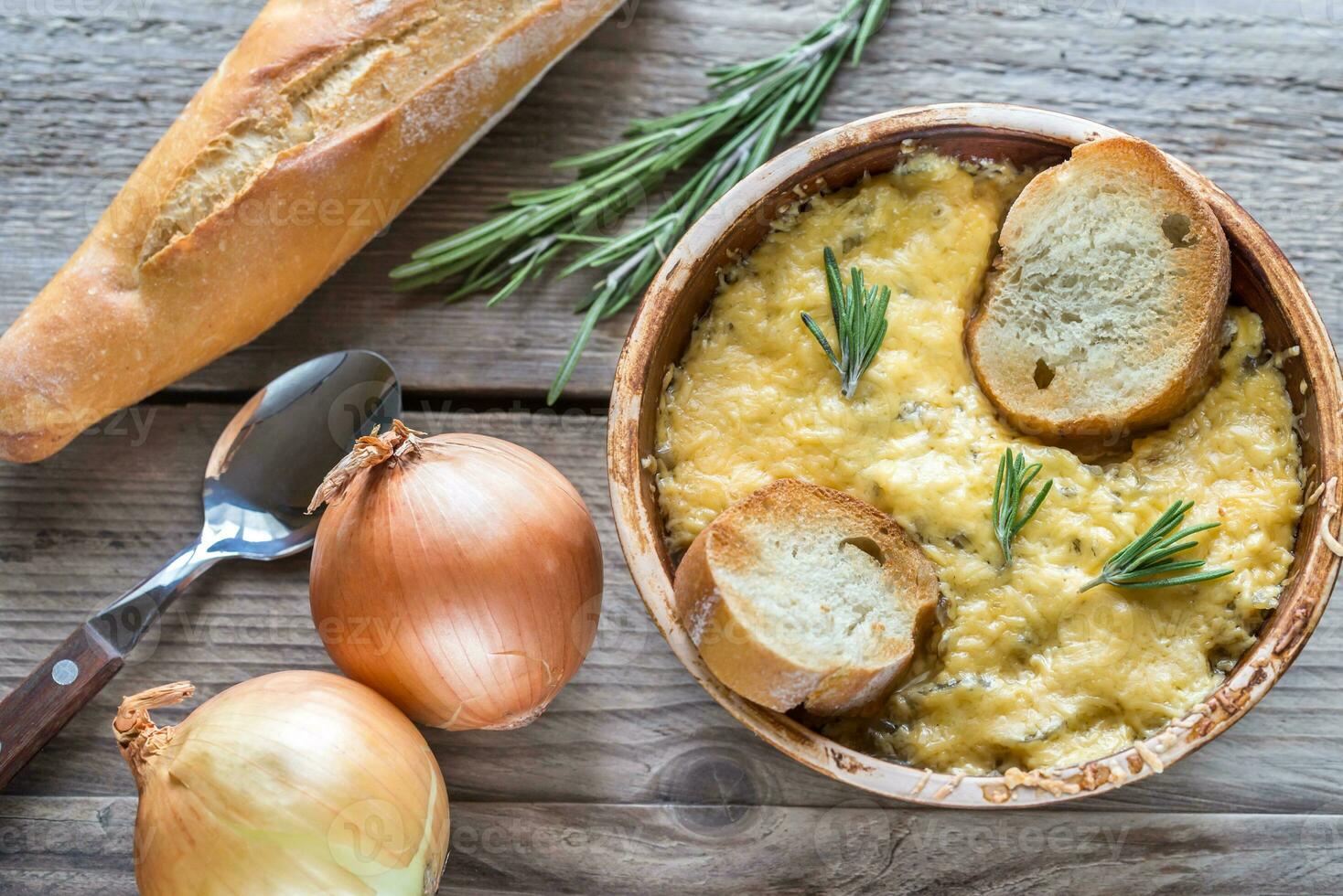 Bowl of onion soup on the wooden table photo